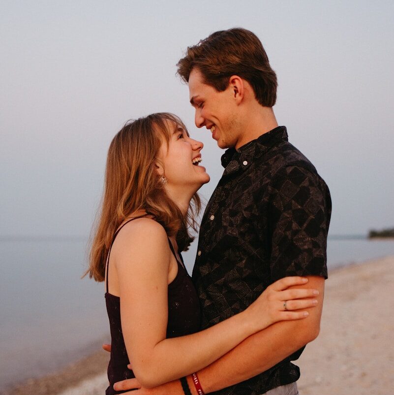 man and woman kissing each other during daytime